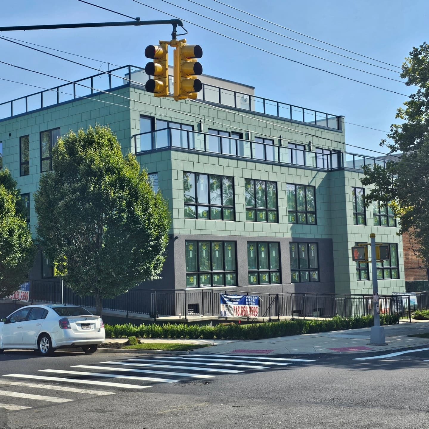 Street-corner view of the green-clad building
