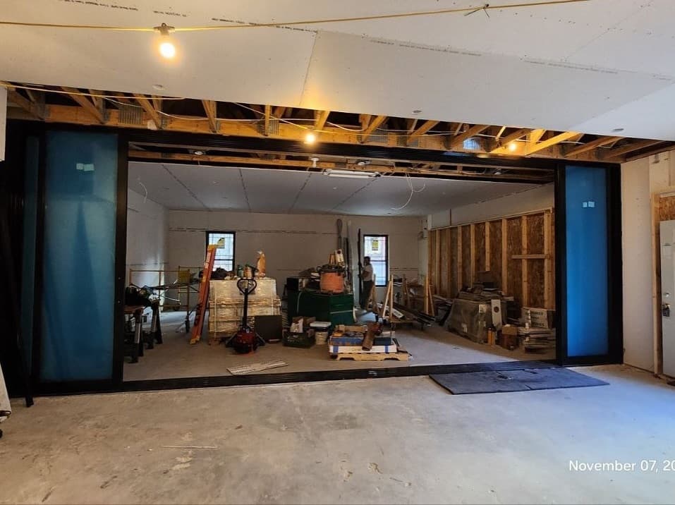 Wide interior view of the open multi-slide system during construction