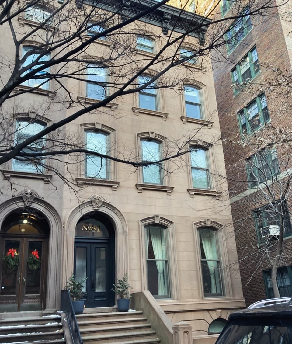 Townhouse facade with shaped stone heads and arched entrances