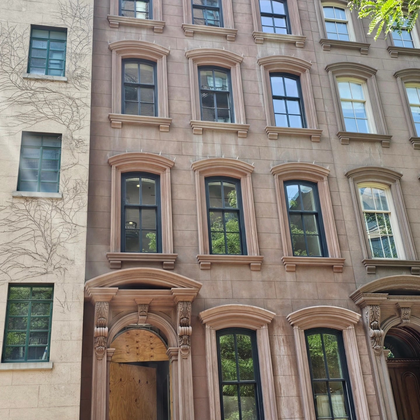 Historic brownstone facade with dark-framed windows