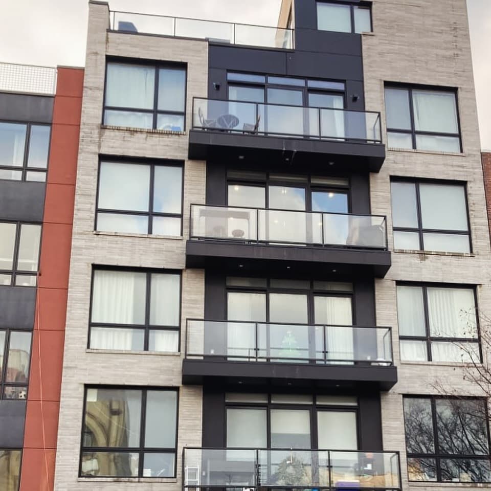 Upper-floor windows and glazed balcony doors