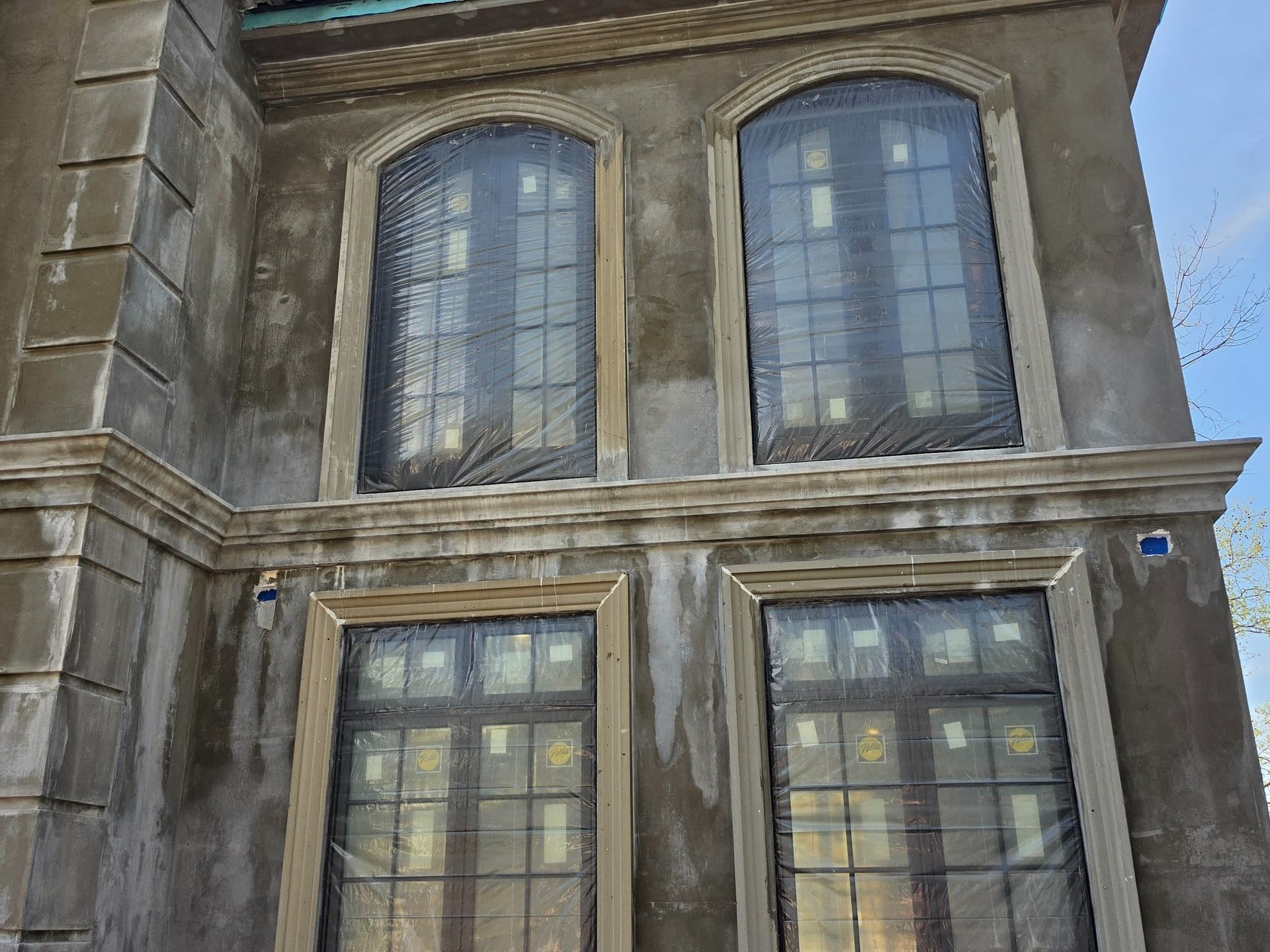 Close exterior view of shaped window heads and divided-light patterns