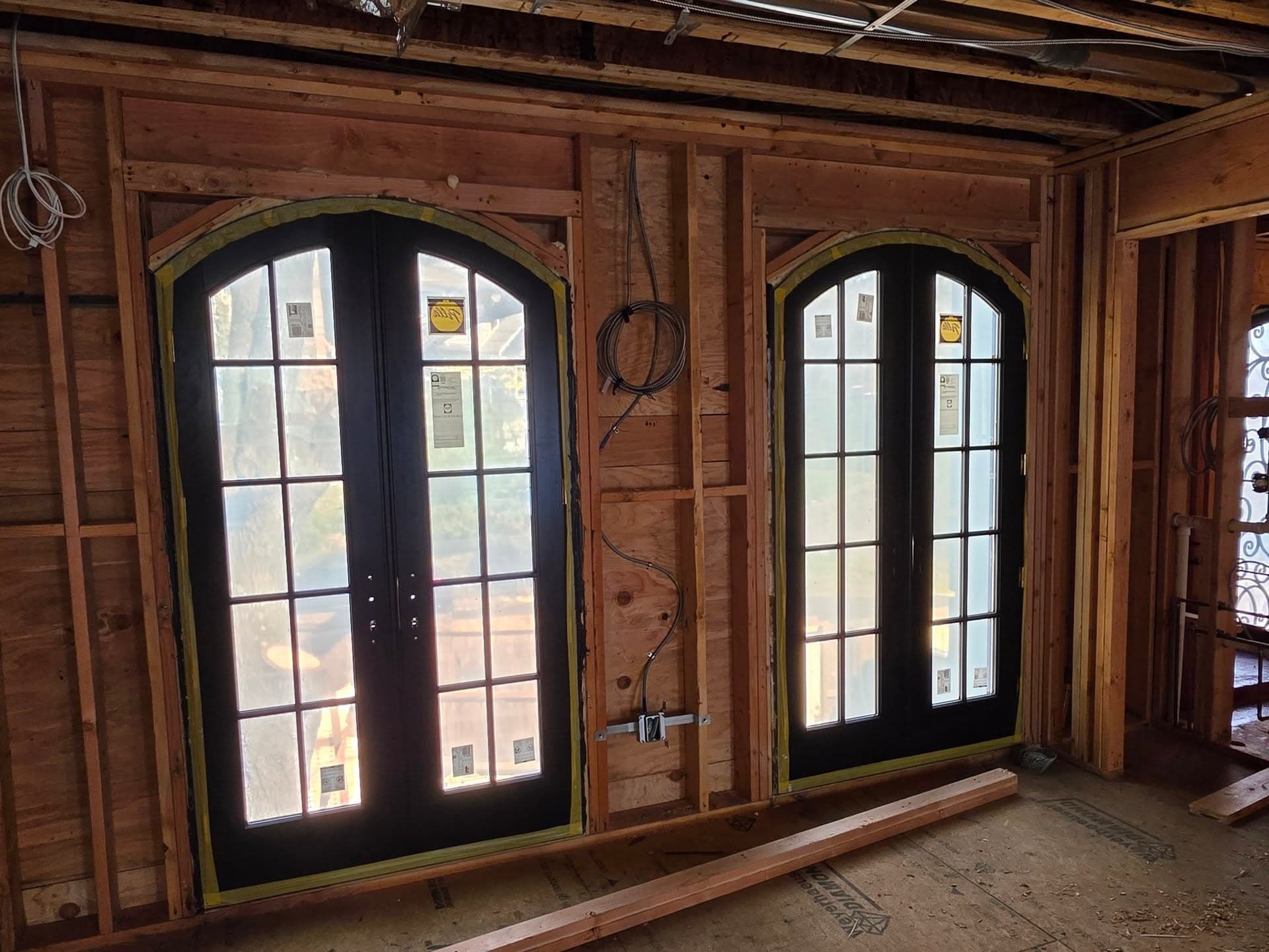 Closer interior view of the arched doors and exposed framing