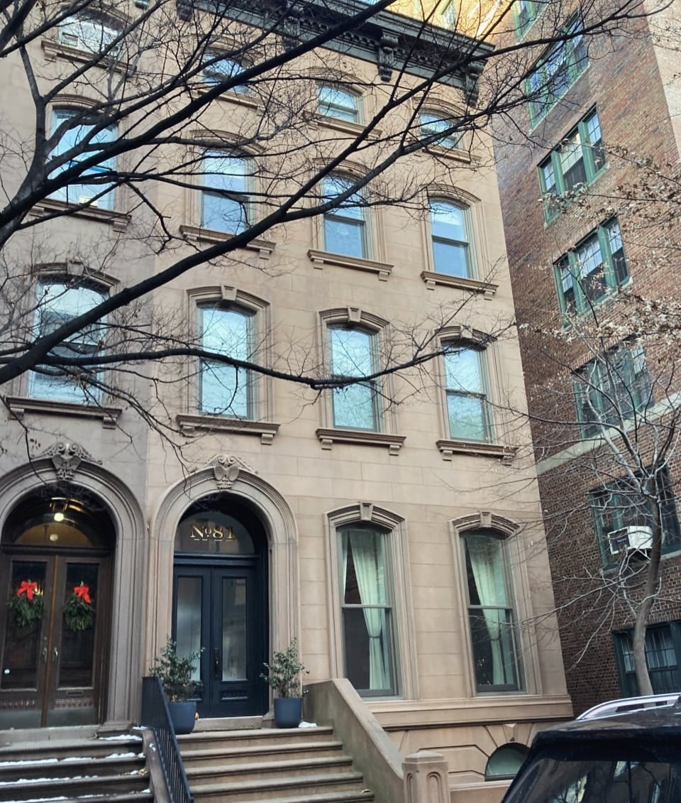 Townhouse facade with shaped stone heads and arched entrances