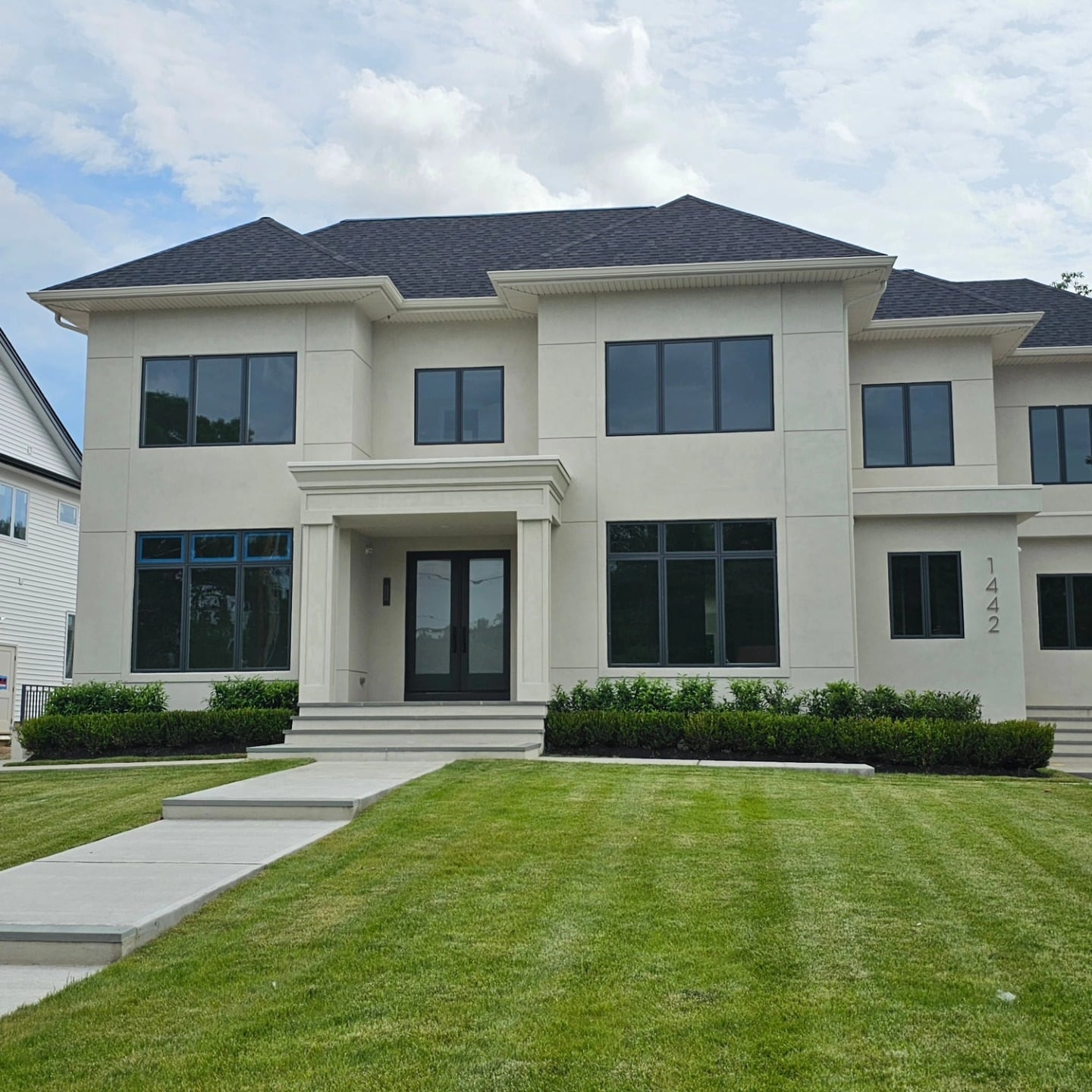 Front elevation of the light-colored residence with Marvin windows