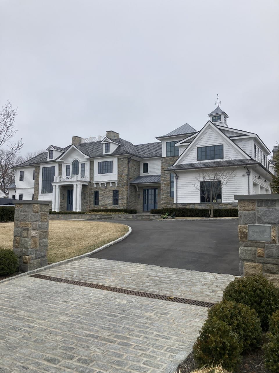 Completed residence viewed from the driveway, showing the full window composition
