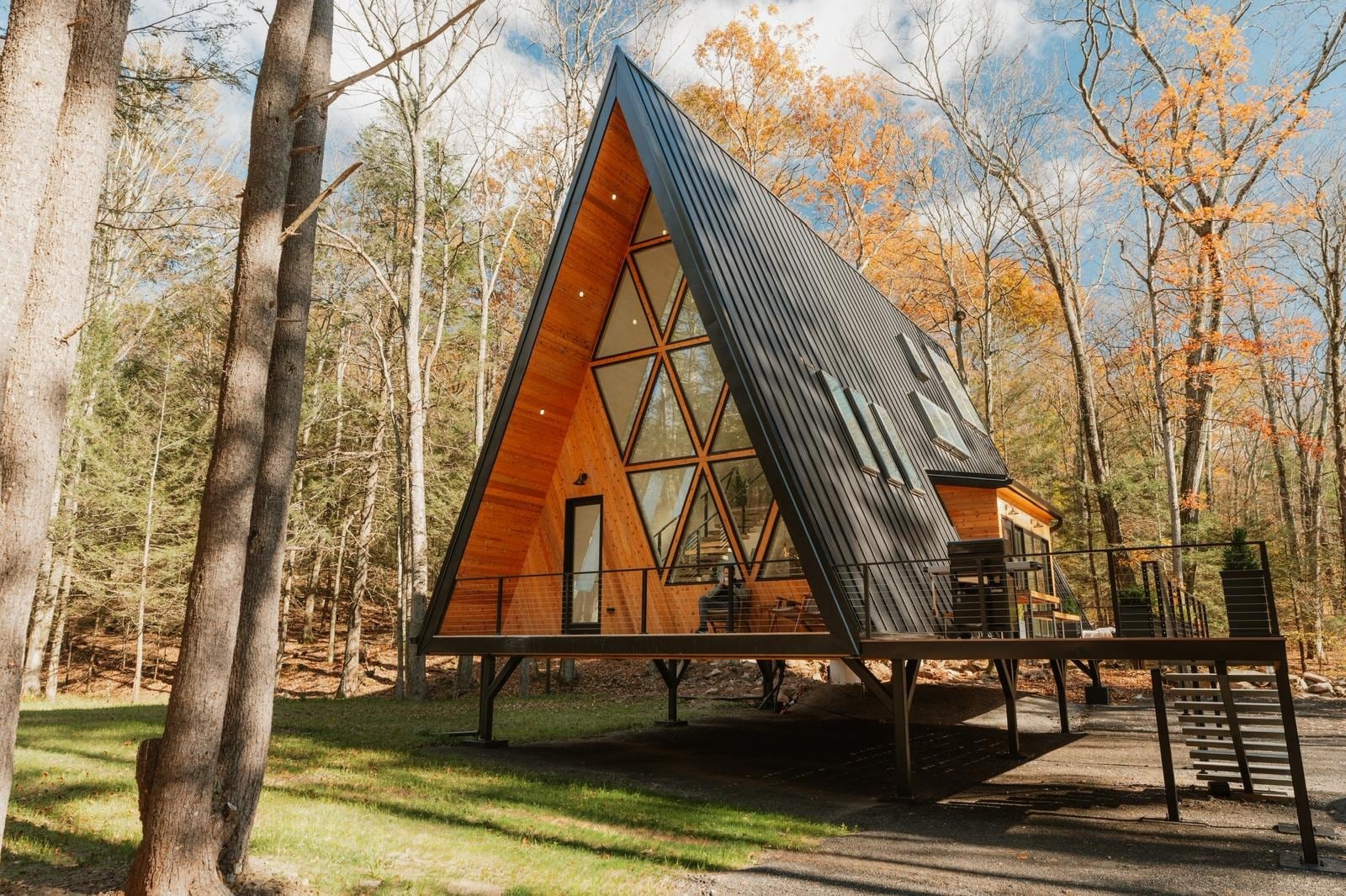 Woodland A-frame with a triangular glazed front and raised deck