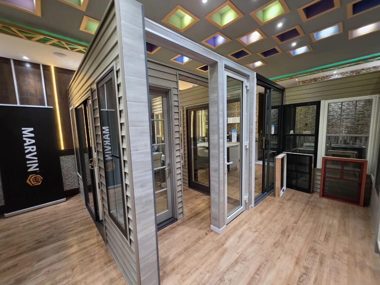 Window samples and glazed door displays around a corner inside the Panorama Art showroom