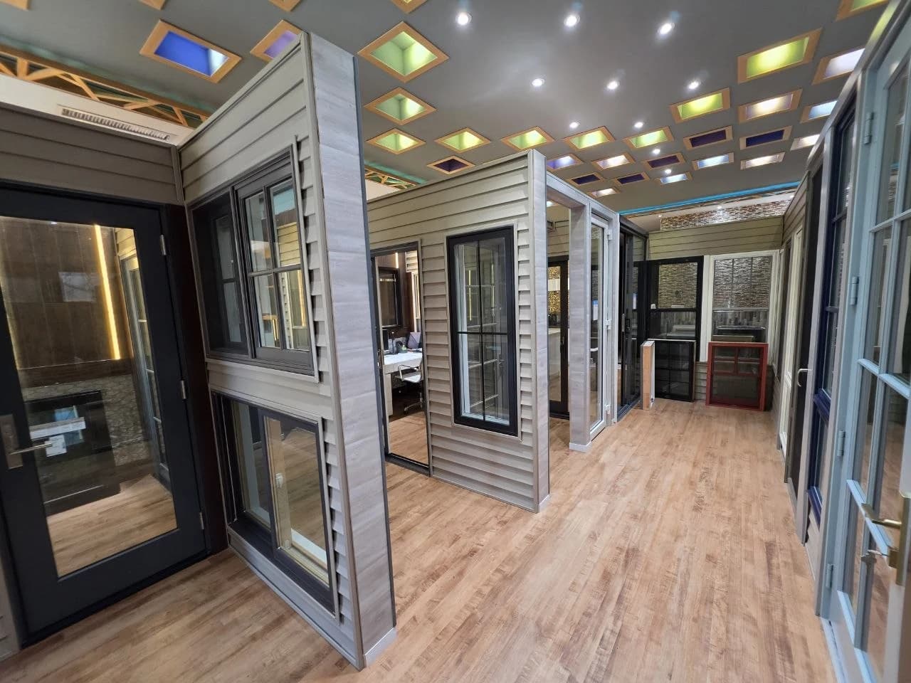Inside the Panorama Art showroom, with full-size window and door displays along the wood-floored gallery